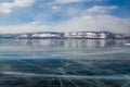 view of ice water surface under cloudy sky during daytime with hills on shore, russia, lake